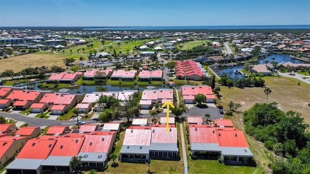 drone / aerial view featuring a residential view and a water view