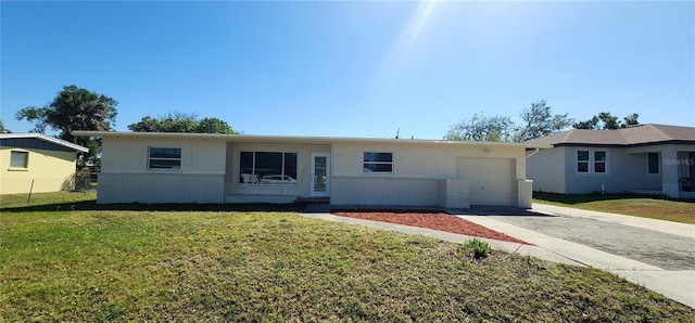 3372 Elkcam Blvd, Port Charlotte, FL 33952 - single story home with a front lawn, an attached garage, brick siding, and driveway