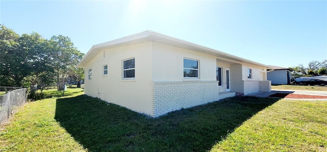 3372 Elkcam Blvd, Port Charlotte, FL 33952 - view of side of property with fence, brick siding, and a lawn