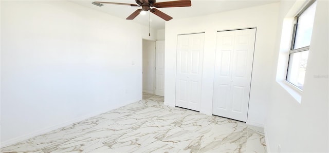 3372 Elkcam Blvd, Port Charlotte, FL 33952 - unfurnished bedroom with marble finish floor, baseboards, multiple closets, and ceiling fan