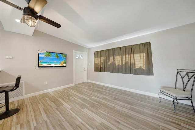 sitting room with baseboards, wood finished floors, a ceiling fan, and vaulted ceiling