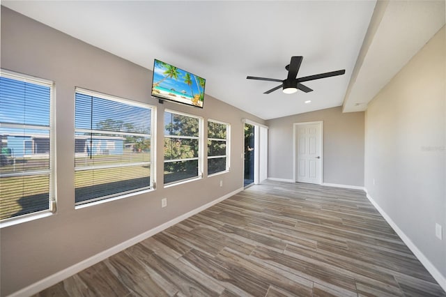 unfurnished sunroom featuring lofted ceiling and a ceiling fan