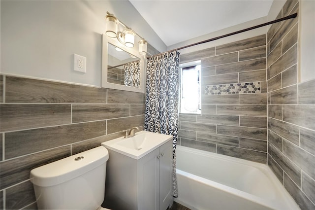 bathroom featuring shower / bath combo with shower curtain, toilet, tile walls, and vanity