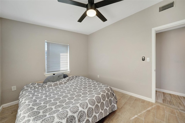 bedroom with visible vents, baseboards, light wood-style floors, and a ceiling fan