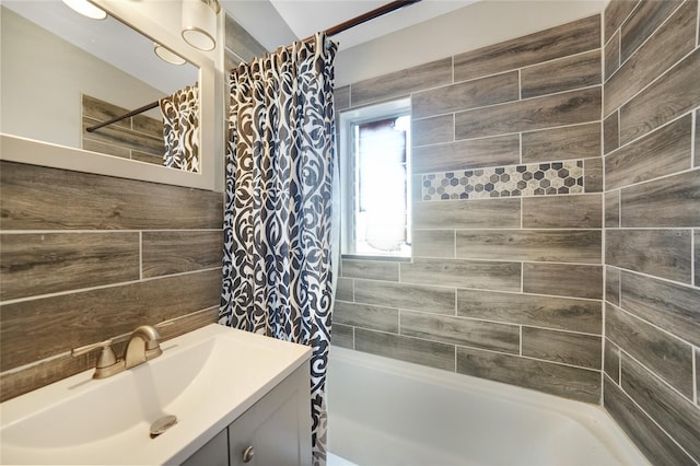 full bathroom with vanity, tile walls, and shower / bathtub combination with curtain