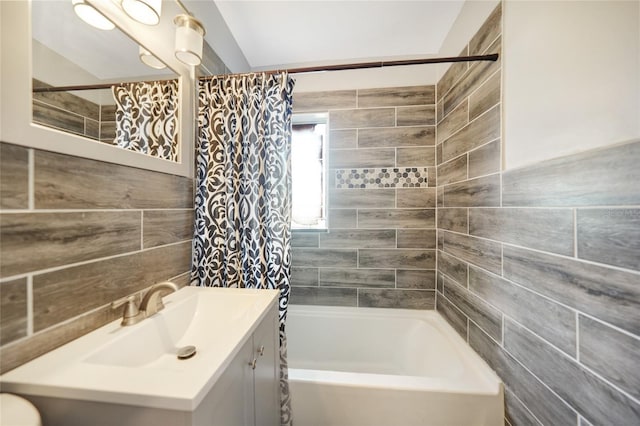 full bath featuring tile walls, vanity, and shower / bath combination with curtain