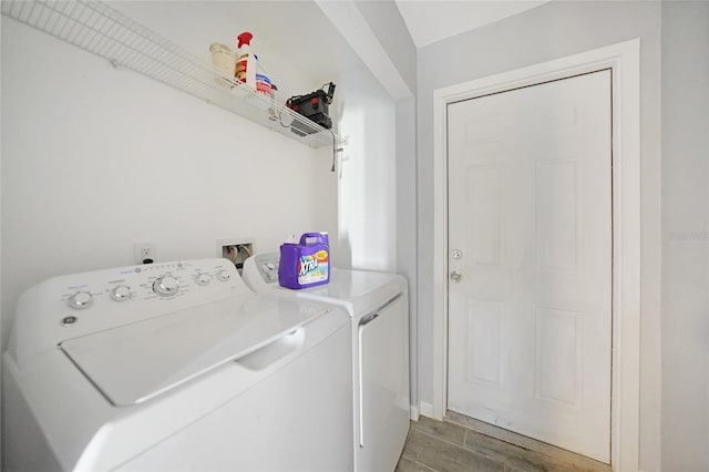 laundry room featuring wood finished floors, laundry area, and washing machine and clothes dryer