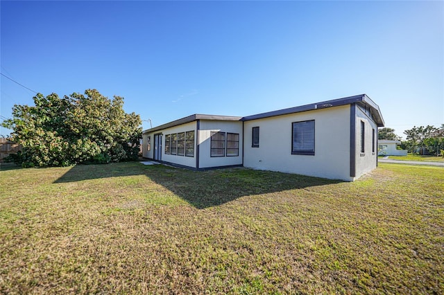 rear view of property with a lawn