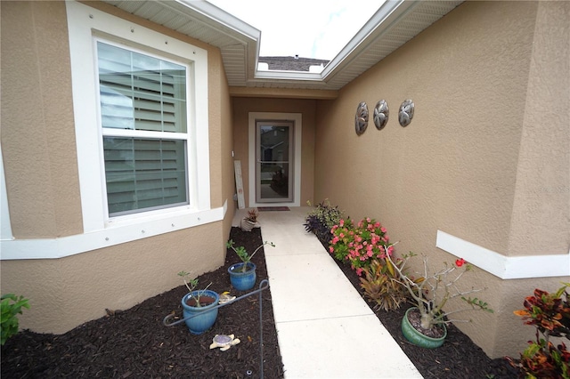 doorway to property with stucco siding