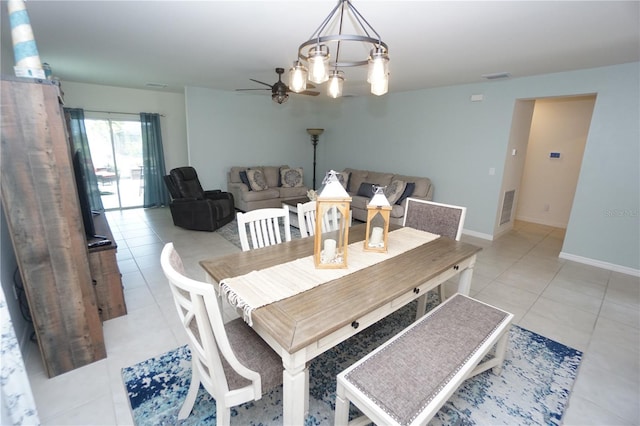 dining space featuring light tile patterned floors, visible vents, and baseboards