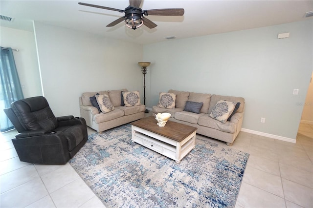 living area featuring light tile patterned floors, visible vents, baseboards, and a ceiling fan