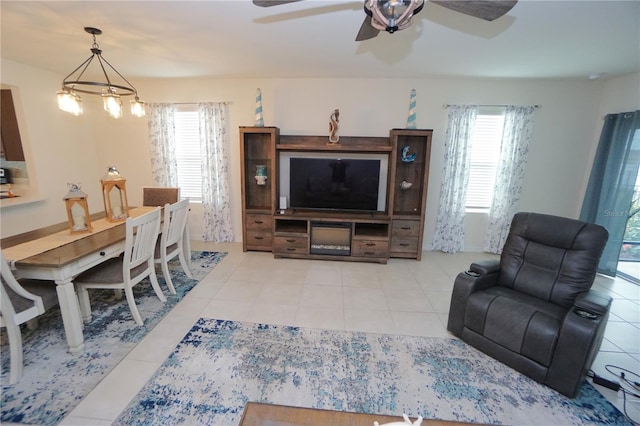 living area featuring light tile patterned floors and ceiling fan