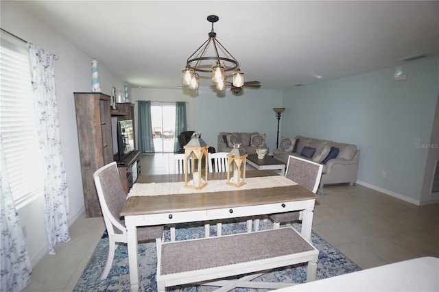 dining area with a notable chandelier, visible vents, baseboards, and light tile patterned floors