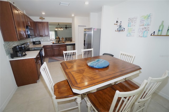 dining area with visible vents, baseboards, light tile patterned floors, recessed lighting, and a notable chandelier