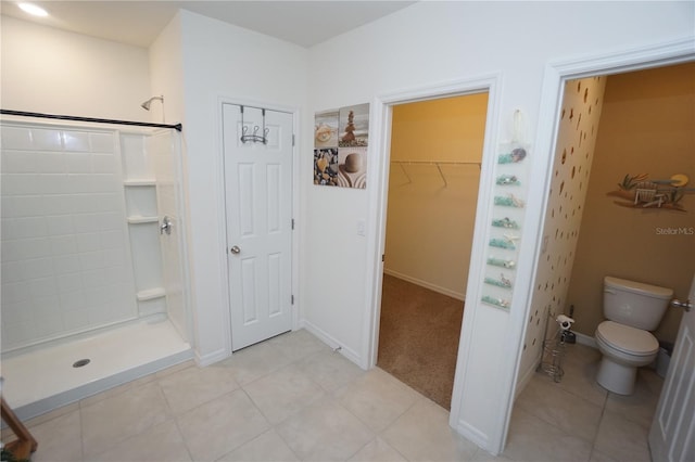 full bath with tile patterned floors, toilet, baseboards, and a stall shower