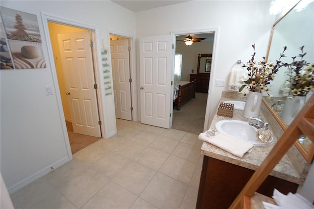 bathroom featuring vanity, ensuite bath, a ceiling fan, and tile patterned floors