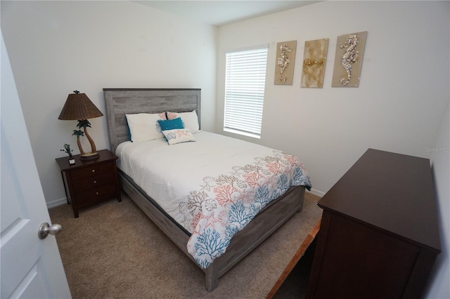 bedroom featuring baseboards and carpet