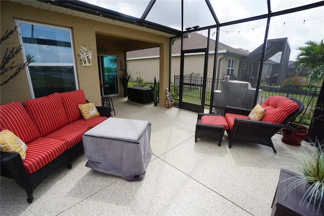 view of patio / terrace with an outdoor living space, fence, and a lanai