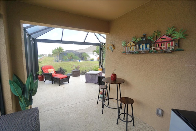 view of patio / terrace featuring glass enclosure