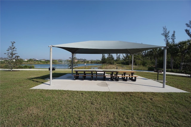 view of property's community featuring a gazebo, a lawn, and a water view