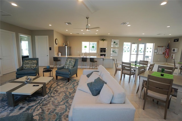 living room with light tile patterned flooring, plenty of natural light, recessed lighting, and a ceiling fan