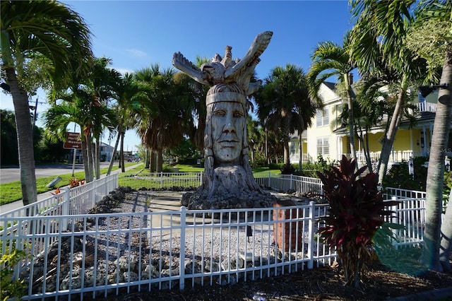 view of home's community featuring fence