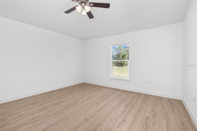 111 Swan Dr, Rotonda West, FL 33947 - spare room featuring light wood-style flooring, baseboards, and a ceiling fan
