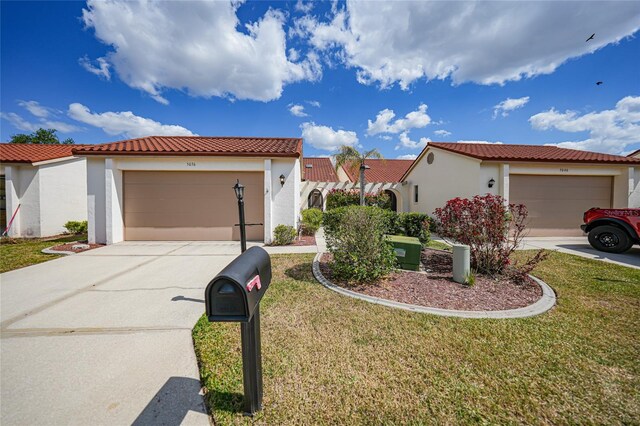 5036 San Rocco Ct, Punta Gorda, FL 33950 - mediterranean / spanish home featuring a front lawn, an attached garage, driveway, and stucco siding