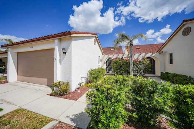 5036 San Rocco Ct, Punta Gorda, FL 33950 - view of home's exterior featuring stucco siding, a garage, concrete driveway, and a tiled roof