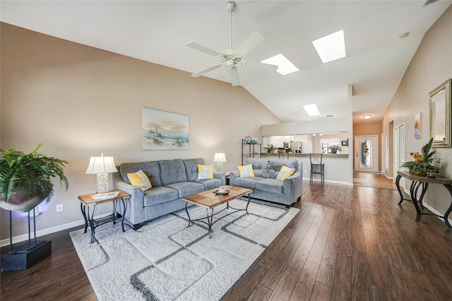 5036 San Rocco Ct, Punta Gorda, FL 33950 - living area featuring baseboards, lofted ceiling with skylight, dark wood-style floors, and a ceiling fan