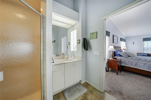 5036 San Rocco Ct, Punta Gorda, FL 33950 - ensuite bathroom with vanity, baseboards, a stall shower, vaulted ceiling, and connected bathroom