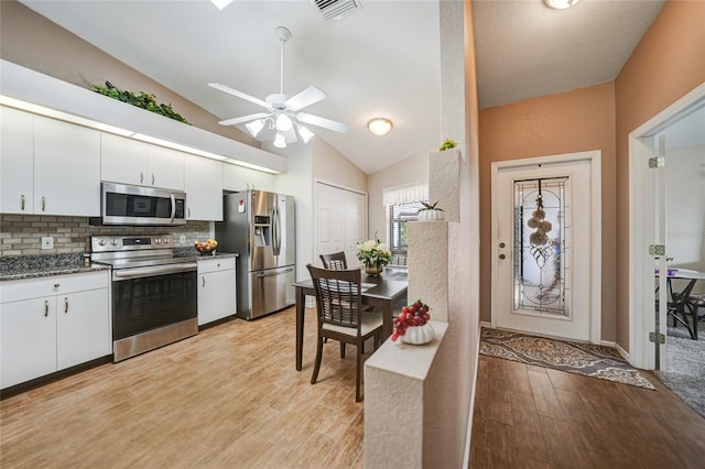 5036 San Rocco Ct, Punta Gorda, FL 33950 - kitchen featuring visible vents, decorative backsplash, light wood-style floors, appliances with stainless steel finishes, and white cabinetry