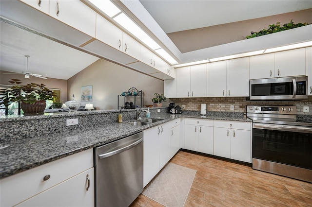 5036 San Rocco Ct, Punta Gorda, FL 33950 - kitchen with white cabinetry, dark stone counters, appliances with stainless steel finishes, and a sink