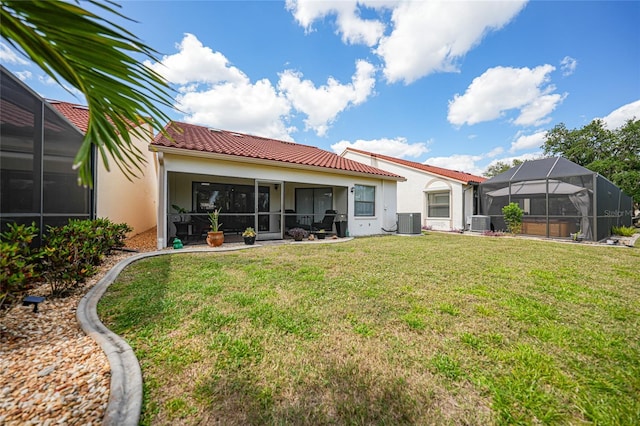5036 San Rocco Ct, Punta Gorda, FL 33950 - rear view of house with a tile roof, stucco siding, cooling unit, and a lawn