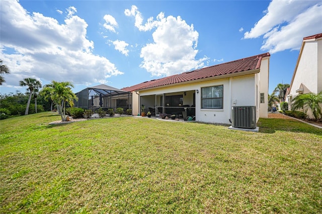 5036 San Rocco Ct, Punta Gorda, FL 33950 - rear view of property featuring stucco siding, central AC, glass enclosure, a yard, and a tiled roof