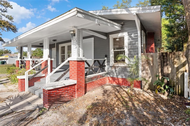 view of front of house featuring a porch and fence
