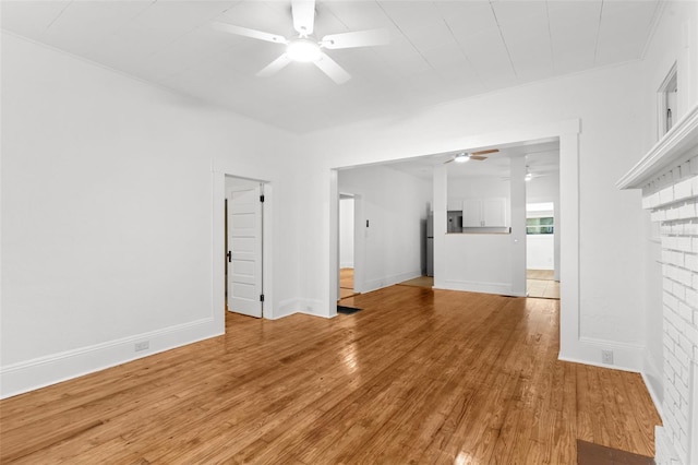unfurnished living room with baseboards, light wood-type flooring, and ceiling fan