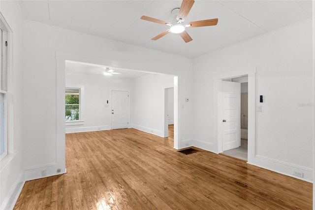 unfurnished room with a ceiling fan, light wood-type flooring, and baseboards