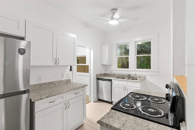 kitchen with a sink, ceiling fan, white cabinetry, and stainless steel appliances