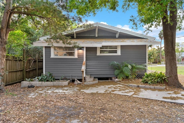 rear view of house featuring fence