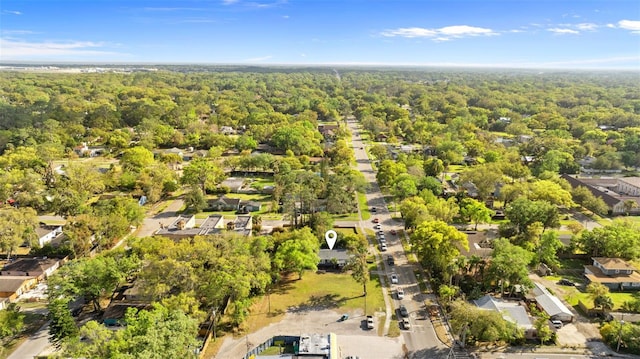 drone / aerial view featuring a view of trees and a residential view