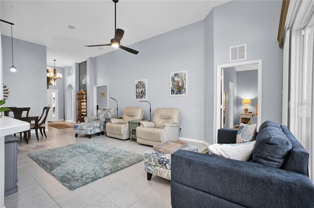 1701 Lastingham Ln, Port Charlotte, FL 33980 - living area with visible vents, high vaulted ceiling, light tile patterned flooring, arched walkways, and ceiling fan with notable chandelier