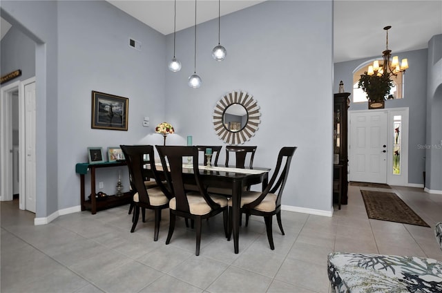 1701 Lastingham Ln, Port Charlotte, FL 33980 - dining room featuring light tile patterned floors, baseboards, visible vents, an inviting chandelier, and a high ceiling
