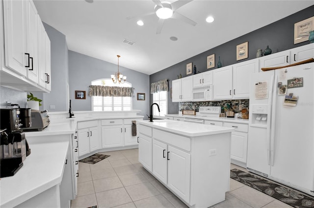 1701 Lastingham Ln, Port Charlotte, FL 33980 - kitchen featuring white appliances, visible vents, a peninsula, a sink, and white cabinetry