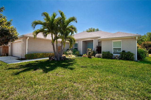 ranch-style home with a front lawn, an attached garage, and stucco siding