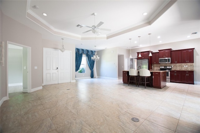 living area featuring visible vents, ceiling fan with notable chandelier, a raised ceiling, and ornamental molding