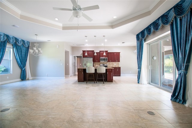 kitchen with stainless steel appliances, a breakfast bar area, light countertops, a raised ceiling, and dark brown cabinets