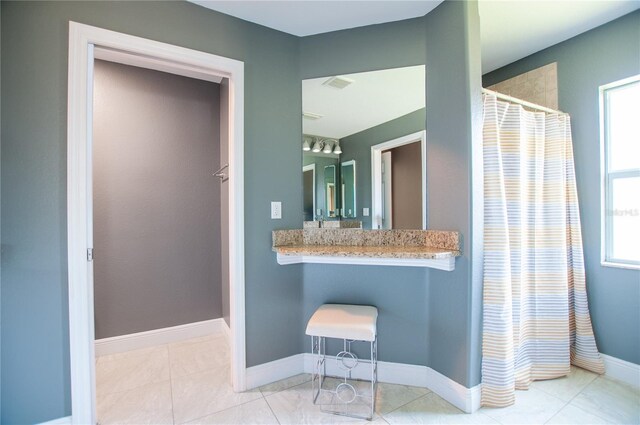 bathroom featuring tile patterned floors, curtained shower, and baseboards