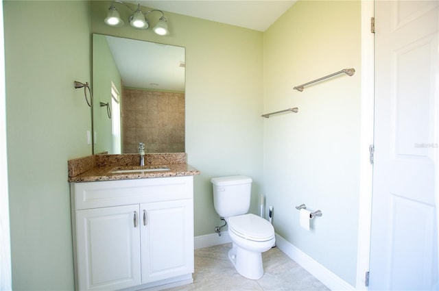 bathroom featuring vanity, toilet, and baseboards