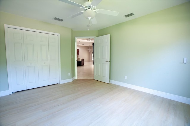 unfurnished bedroom featuring baseboards, visible vents, and light wood-type flooring